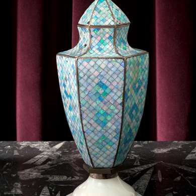A silver urn decorated with opals forming a mosaic