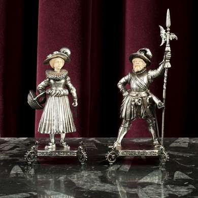 A pair of silver figures of a gardener and a medieval guard